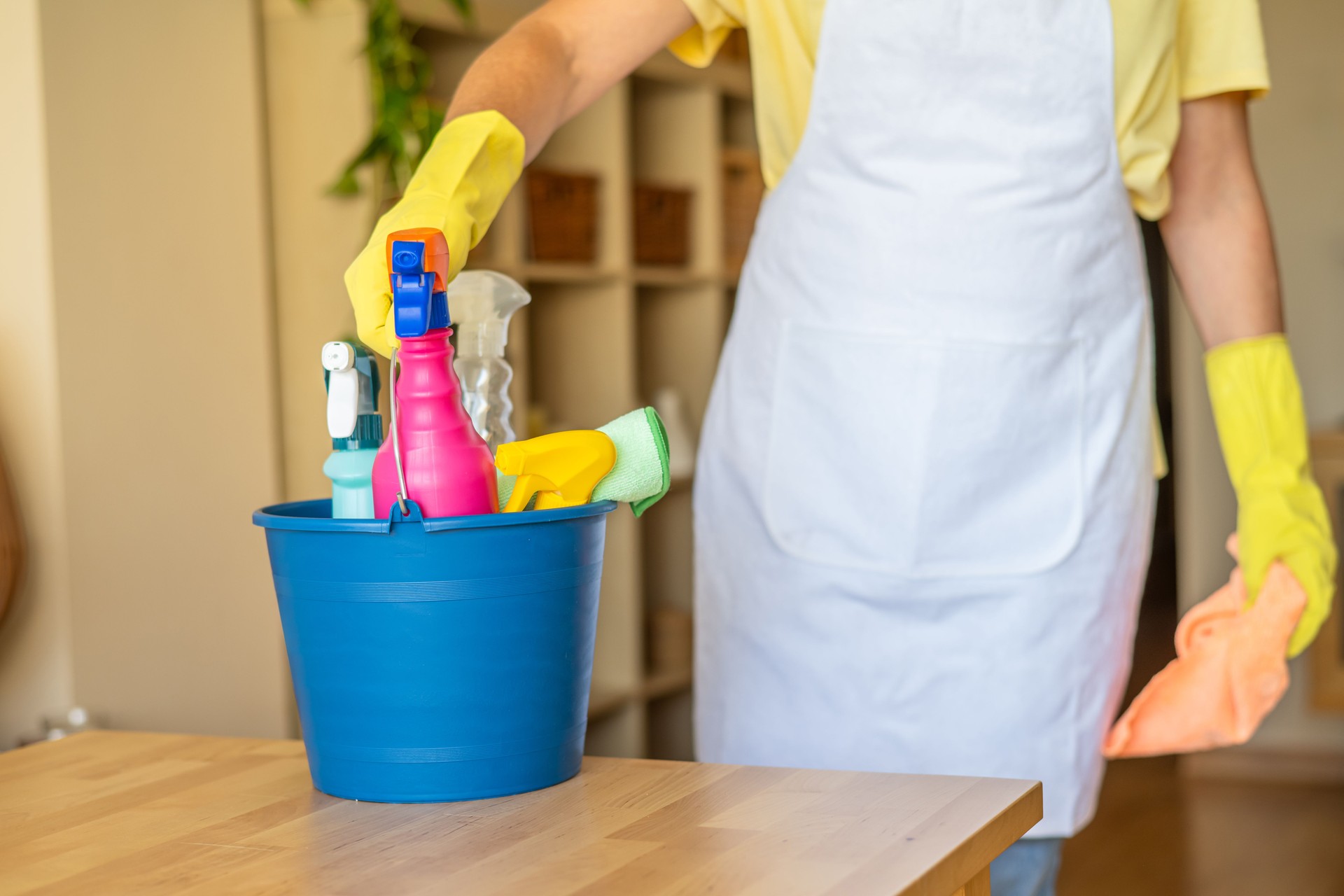 Close-Up Of Cleaning Professional Holding Bucket Of Supplies For Residential Cleaning And Sanitation Services, Wearing Gloves And Ready To Provide Efficient And Thorough Household Care